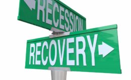 A recession and a recovery sign pointing in opposite directions