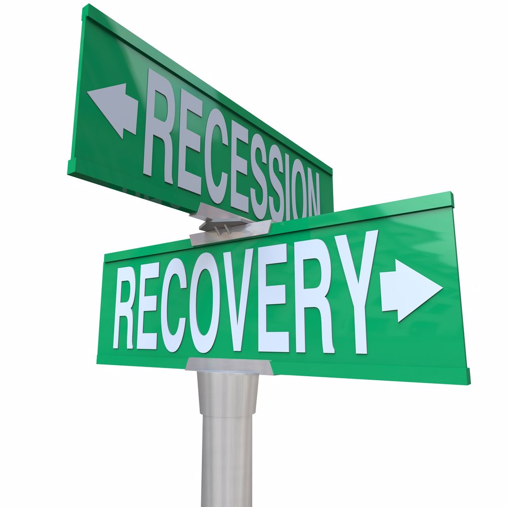 A recession and a recovery sign pointing in opposite directions