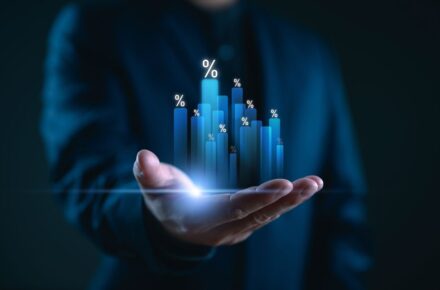 Hand holding graph with percentage, special offer of shopping department store discount and tax concept, adjusting interest rates, raising interest rates to fight inflation, returns on investments.