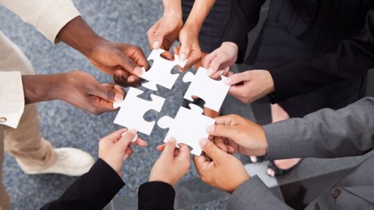 Workers put puzzle pieces together