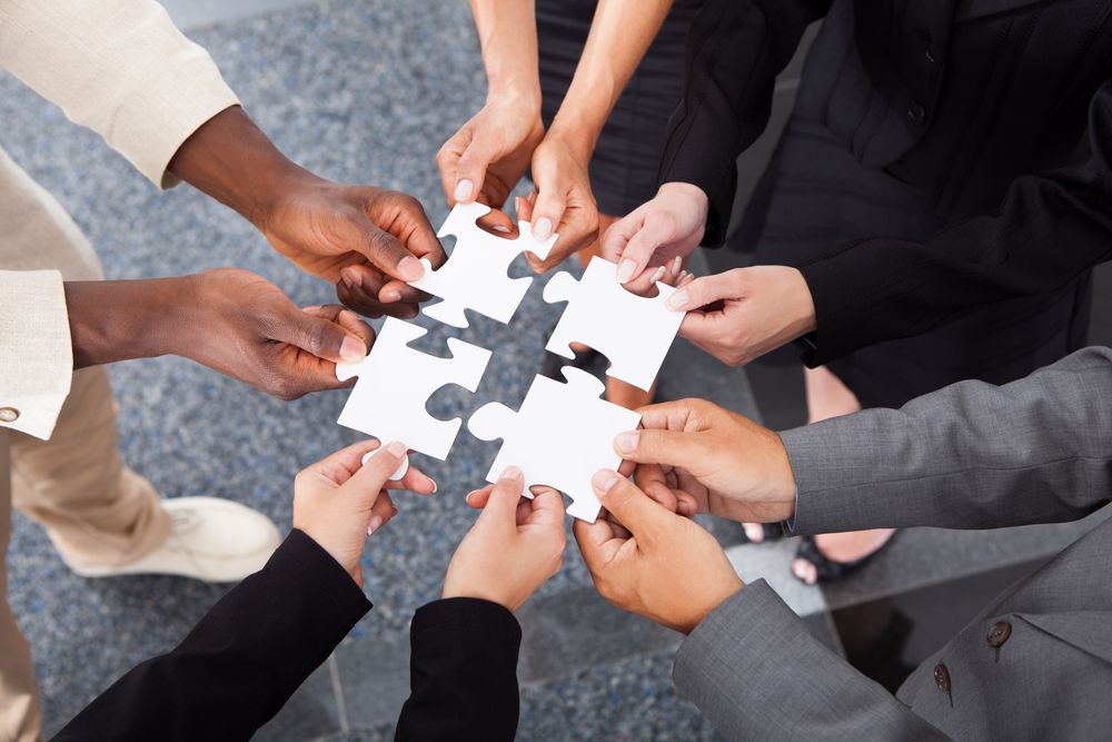 Workers put puzzle pieces together