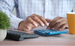 Man typing on calculator
